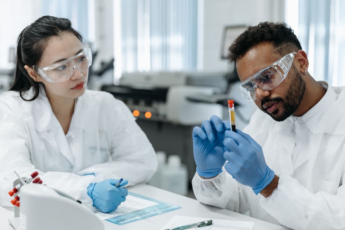 Laboratory technicians reviewing analytical results